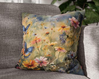 May include: A throw pillow with a watercolor design of butterflies and flowers in shades of blue, yellow, pink, and green.