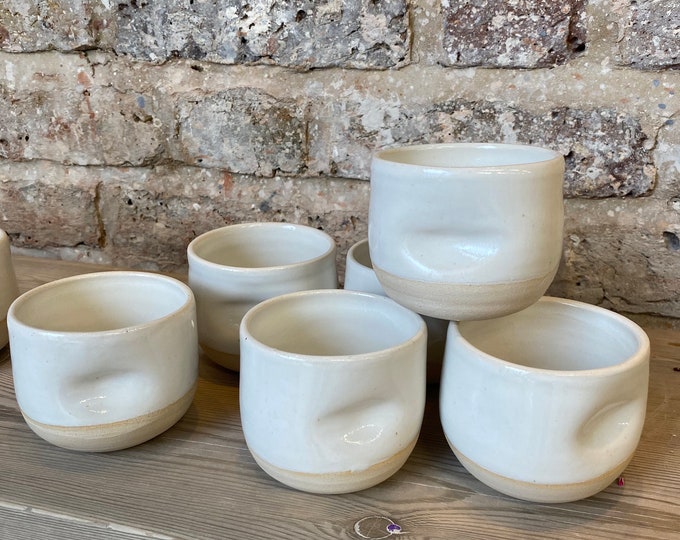Flat white coffee cup with thumb dimple