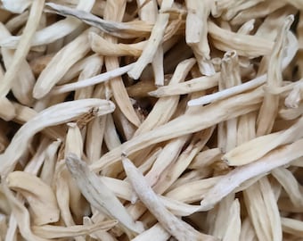 May include: A collection of dried, pale beige lily buds, each featuring a slender, elongated, and slightly curved shape with a fibrous texture. The buds are densely packed together, displaying variations in tone from off-white to light tan.