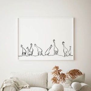 May include: A black and white line art print of a group of giraffes standing in a line. The print is framed in a white frame and is hanging on a white wall.