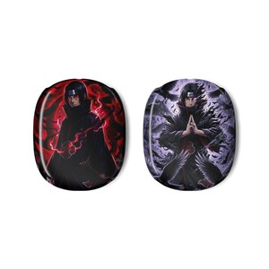 May include: Two oval-shaped accessories featuring anime characters. One has a red background with a character in a black cloak. The other has a purple background with a character in a black cloak and birds.