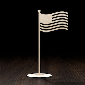 May include: A wooden American flag tabletop decoration with a white base. The flag is waving in the wind.