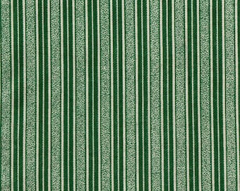 May include: Green and white striped fabric with a repeating pattern. The fabric has vertical stripes of varying widths, including solid green, white, and dotted white stripes. A ruler is at the bottom with the months January to June.
