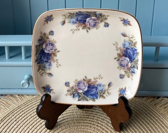 May include: A set of miniature porcelain figurines featuring a blue and white floral design. The set includes a shoe, a wheelbarrow, a thimble, a basket, and a swan.