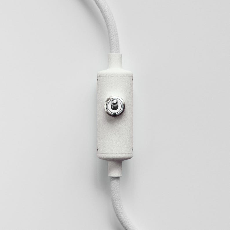 May include: White cord with a white on/off switch with a silver knob.