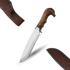 May include: A hunting knife with a brown wooden handle shaped like an animal head. The knife has a silver blade and comes with a brown leather sheath.