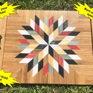 May include: A wooden serving tray with a geometric starburst design in black, white, red, and blue. The tray has two black metal handles and the text "Dawn's New Day Creations" is visible in the lower right corner.