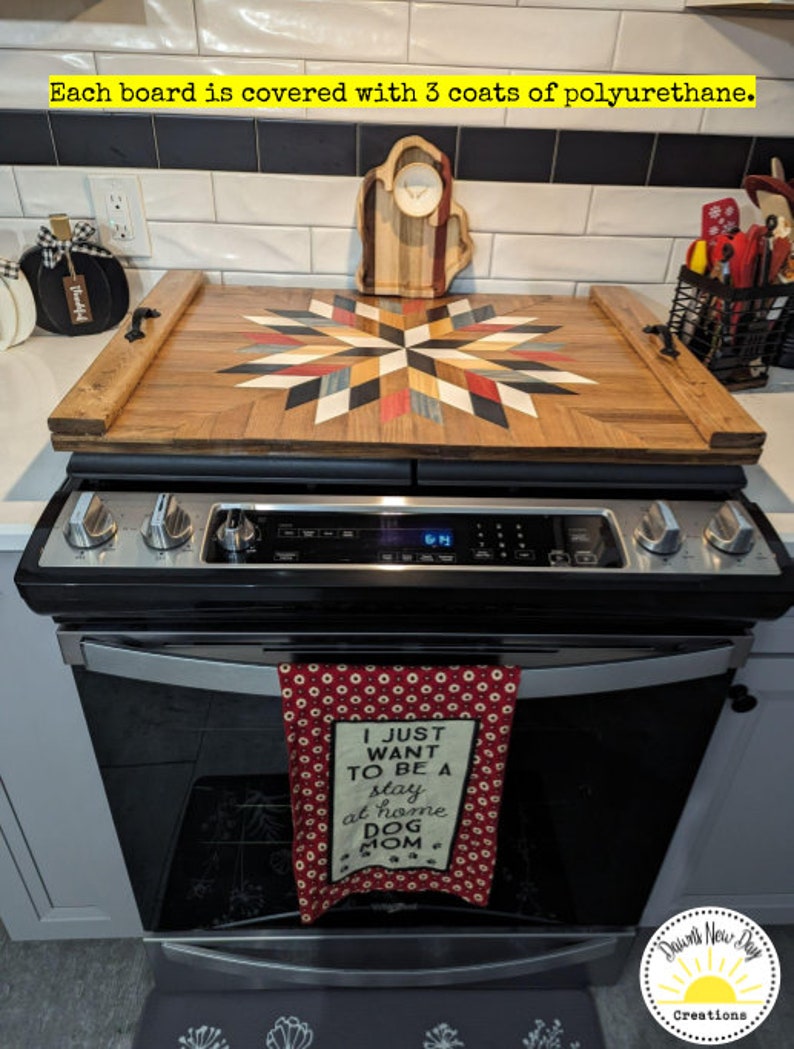 May include: A wooden serving tray with a colorful geometric design. The tray is sitting on top of a black and silver stove. The tray has a handle on each side and is made of wood. The tray is covered in a clear polyurethane finish. The tray is decorated with a colorful geometric design. The tray is sitting on top of a black and silver stove. The tray has a handle on each side and is made of wood. The tray is covered in a clear polyurethane finish.