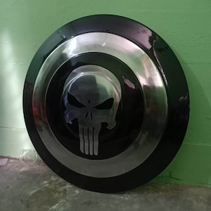 May include: A black and silver Captain America shield with a silver skull design in the center.