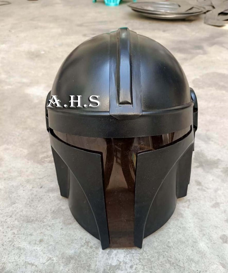 May include: A black helmet with a dark visor, featuring the text "A.H.S" on the front. The helmet has a rounded top with a central ridge and angular side pieces, suggesting a futuristic or sci-fi theme.