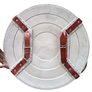 May include: A silver metal shield with a red star in the center and brown leather straps on the back.