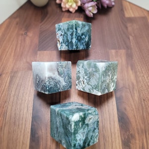 May include: Four green and white moss agate cubes. The cubes are polished and have a natural, organic look.