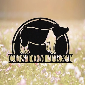 May include: Black metal silhouette of a pig in a circle with the text "CUSTOM TEXT" below. The pig is standing on a field of flowers.