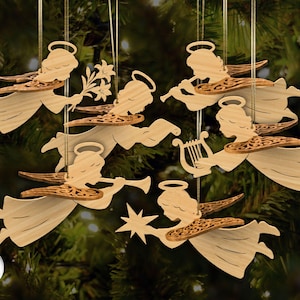 Könnte beinhalten: Holzengel-Ornamente mit detaillierten Flügeln und Heiligenscheinen. Jeder Engel wird im Flug dargestellt, einige halten Musikinstrumente, Blumen oder einen Stern. Die Ornamente sind an goldenen Schnüren aufgehängt, ideal für den Weihnachtsbaum.