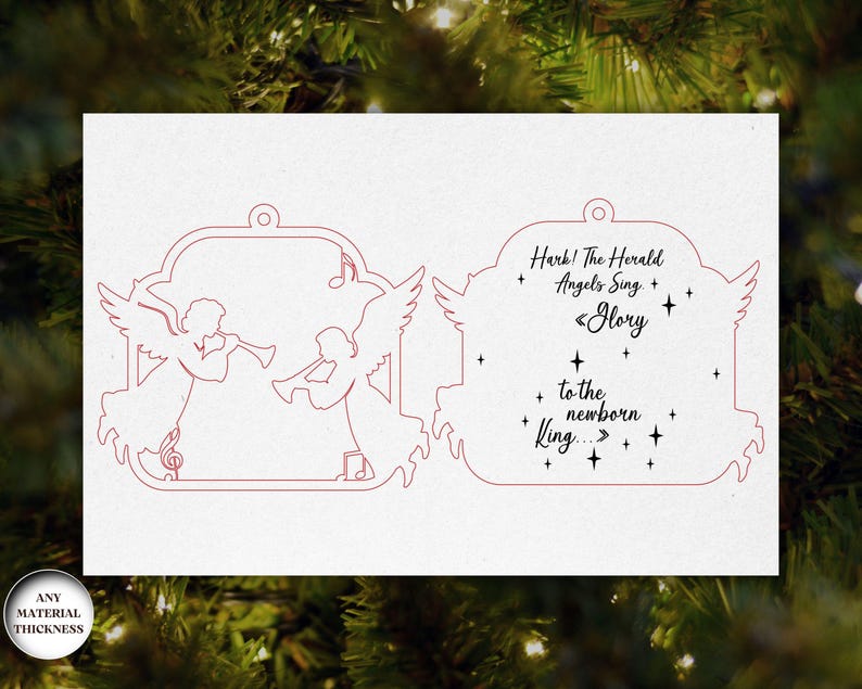 May include: A white Christmas ornament with a red outline of two angels playing trumpets. The ornament has the text "Hark! The Herald Angels Sing, Glory to the newborn King..." in a decorative font. The ornament is designed for any material thickness.