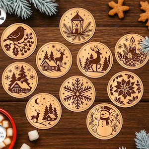 May include: A set of ten wooden coasters with various winter-themed designs. Each coaster features a different laser-cut image, including a bird, deer, snowflake, and snowman. The coasters are arranged on a wooden surface.