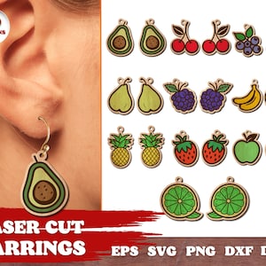 May include: Ten designs of laser cut fruit earrings. The earrings are made of wood and feature various fruits, including avocados, cherries, blueberries, pears, blackberries, bananas, pineapples, strawberries, apples, and limes. The earrings are shown on a white background.