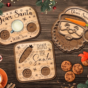 May include: Wooden Christmas serving trays with festive text and designs. One tray features a Santa face, another says "Dear Santa," and the third says "Treats for Santa." Each tray has spaces for cookies, carrots, and drinks.
