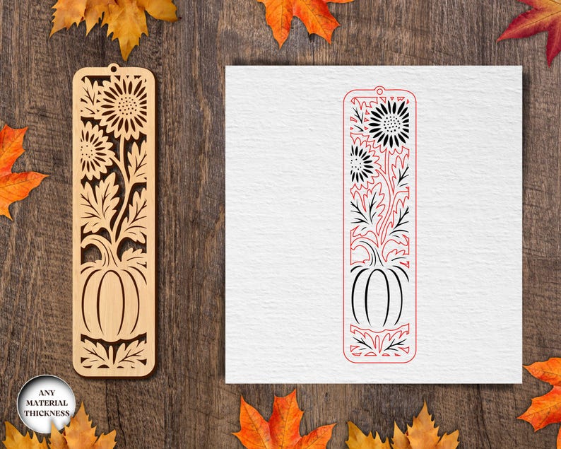 May include: Wooden bookmark with a laser-cut design featuring sunflowers and a pumpkin. The bookmark is light brown and has a rectangular shape with a hole at the top. The design is intricate and detailed, perfect for fall or autumn-themed gifts.