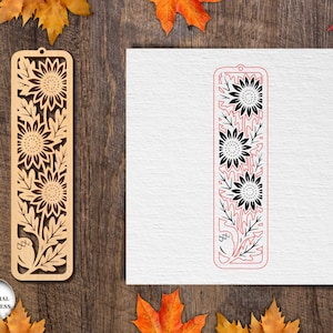 May include: Wooden bookmark with a sunflower design. The bookmark is light brown and features cut-out sunflowers and leaves. A second bookmark design is shown in red and black on a white background. The words "ANY MATERIAL THICKNESS" are in a circle.