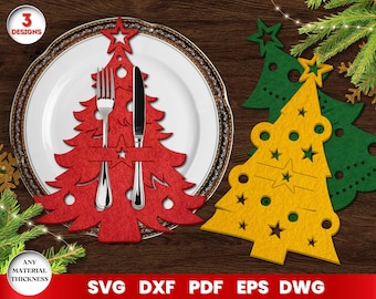 May include: Three Christmas tree designs for crafting. The trees are red, yellow, and green. The red tree has a cutout for a fork and knife. The text "3 Designs" is at the top of the image.
