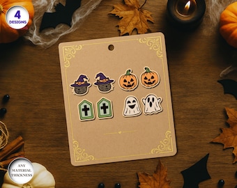 May include: A set of Halloween-themed earrings displayed on a tan card. The earrings feature designs of black cats in witch hats, jack-o'-lanterns, tombstones, and ghosts. The card is decorated with gold filigree.