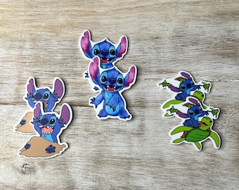 May include: A collection of colorful stickers featuring the character Stitch from the animated film Lilo & Stitch. The stickers depict Stitch in various poses, including on a turtle and emerging from sand. The stickers are on a wooden surface.