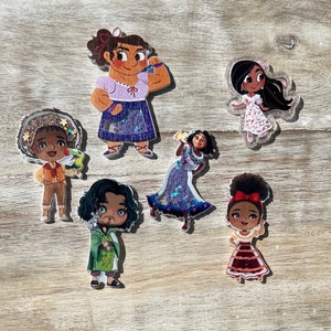 May include: Set of six colorful cartoon character stickers. The characters are a girl with brown hair wearing a purple dress, a girl with brown hair wearing a pink dress, a girl with brown hair wearing a red dress, a boy with brown hair wearing a blue shirt, a boy with brown hair wearing a green shirt, and a boy with brown hair wearing a yellow shirt.