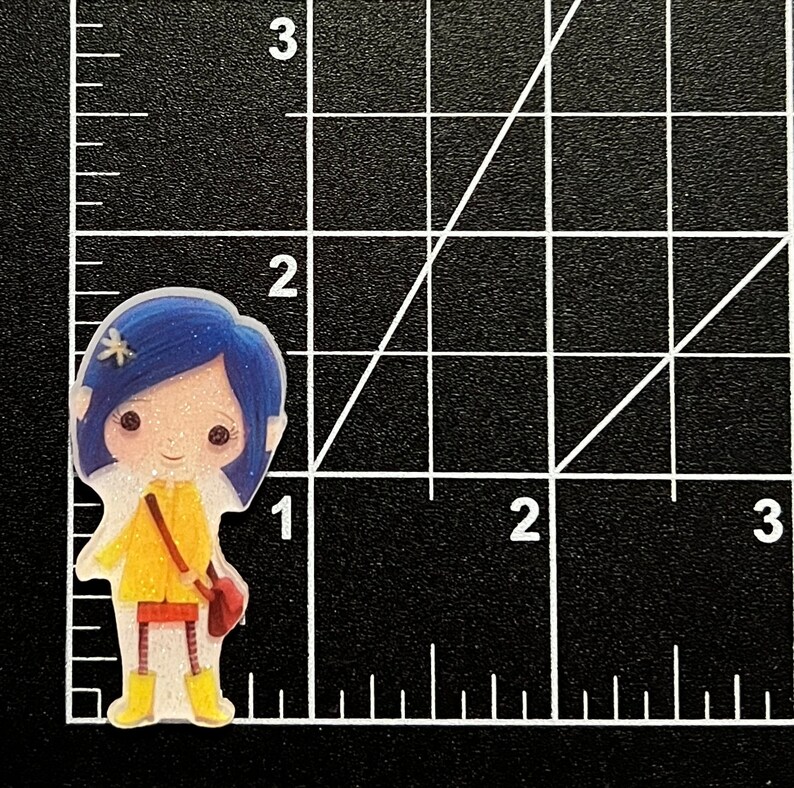 May include: A glittery, cartoon-style character with blue hair, a yellow raincoat, and red boots. The character is holding a brown bag and has a white flower in her hair.