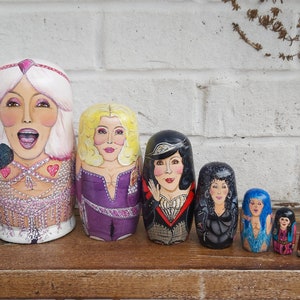 The 7 ages of Cher dolls, 'turn back time' from her Believe and Mama Mia eras all the way to her 60s era with Sonny.