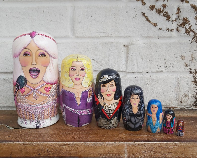 The 7 ages of Cher dolls, 'turn back time' from her Believe and Mama Mia eras all the way to her 60s era with Sonny.