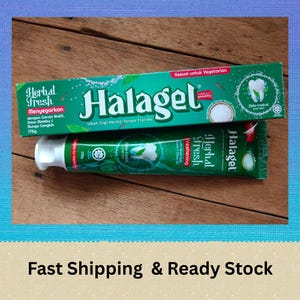 May include: Two tubes of Halagel Herbal Fresh toothpaste and a box, all in green and white. The box and tube feature the Halagel logo and text in a foreign language. The box also has the text "Sesuai untuk Vegetarian".