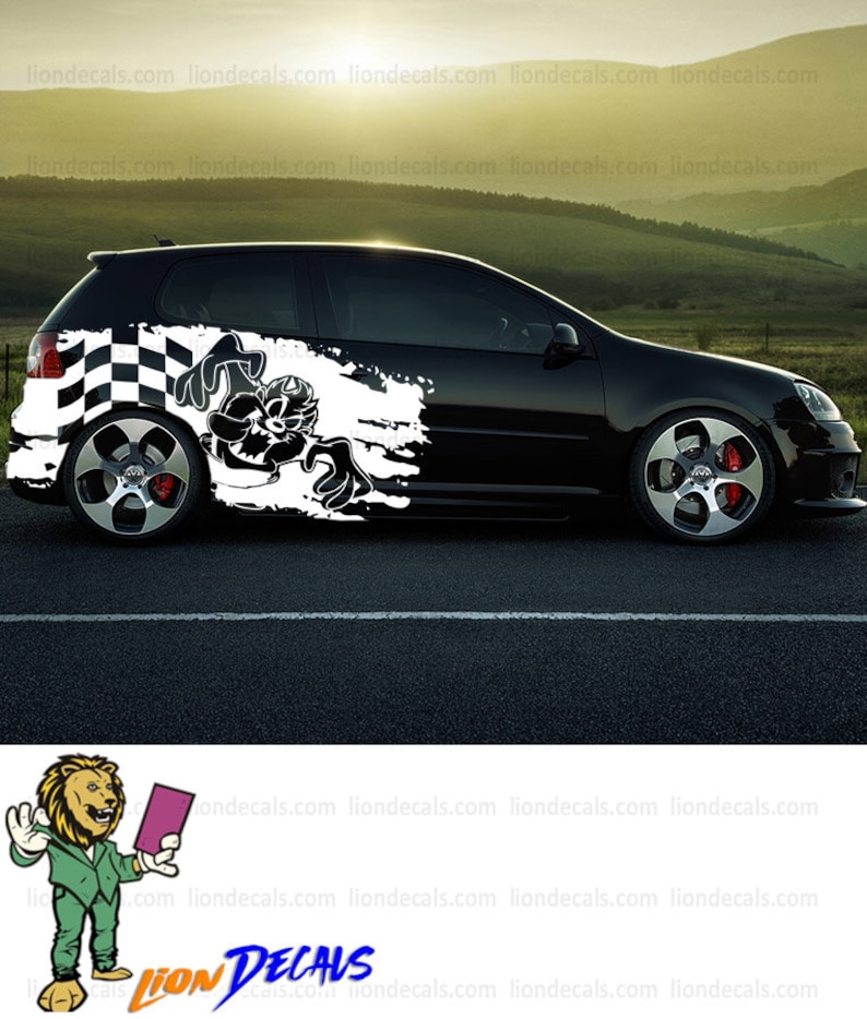 May include: Black car with a white checkered flag and a cartoon character graphic on the side. The graphic is a black and white illustration of a cartoon character with a mischievous expression. The car is on a gray asphalt surface.