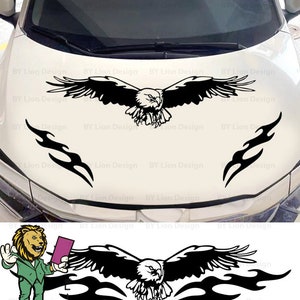 May include: Black and white decal of an eagle with wings spread and flames on either side. The decal is on a white car hood. The decal is for a car hood.