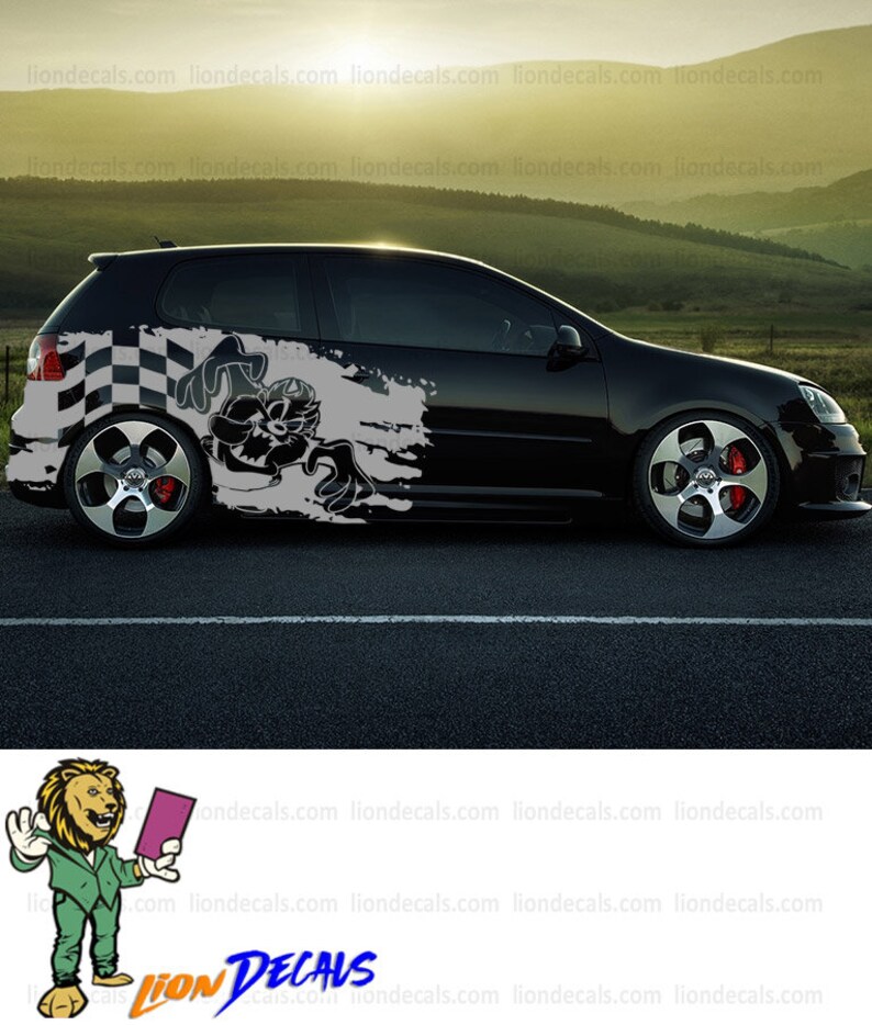 May include: Black car with a cartoon character and checkered flag graphic decal on the side. The decal is in gray and white. The car is on a black asphalt road.