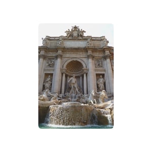 May include: A low-angle shot of the Trevi Fountain in Rome, Italy. The Baroque fountain features sculptures of mythical figures, cascading water, and a large central statue. The architecture is detailed and ornate, with statues and carvings.