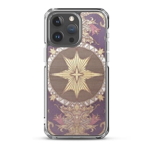 May include: A clear phone case with a vintage design featuring a large, gold star in a circle surrounded by smaller stars. The background is a purple and gold floral pattern.