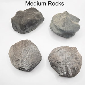 May include: Four medium-sized grey rocks with a rough, textured surface. The rocks are arranged in a square pattern on a white background. The text "Medium Rocks" is written in black at the top of the image.