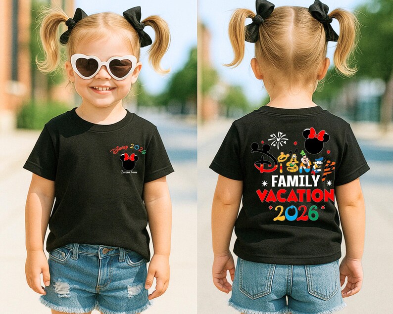 May include: Black t-shirt with a Minnie Mouse graphic and the text "Disney 2026" on the front. The back of the shirt features the text "Disney Family Vacation 2026" with various Disney character graphics. The child is wearing denim shorts.