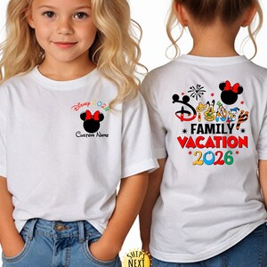 May include: White t-shirt featuring a Minnie Mouse design with a red bow and the text "Disney 2026". The back of the shirt displays "Disney Family Vacation 2026" with character graphics. The shirt is worn by a child.