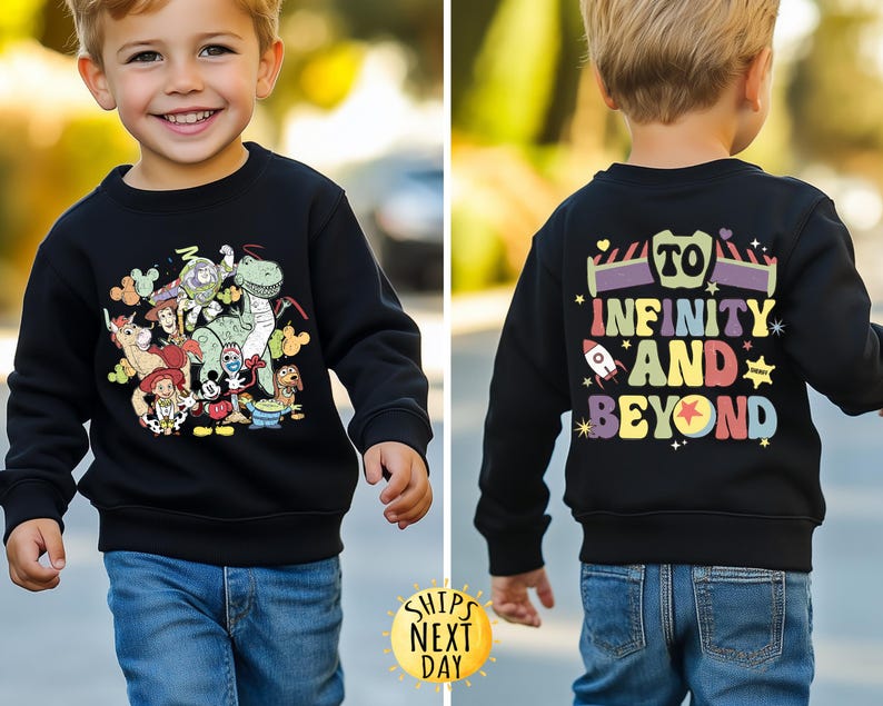 May include: Black sweatshirt with a colourful graphic of Toy Story characters on the front and the text "To Infinity and Beyond" on the back.