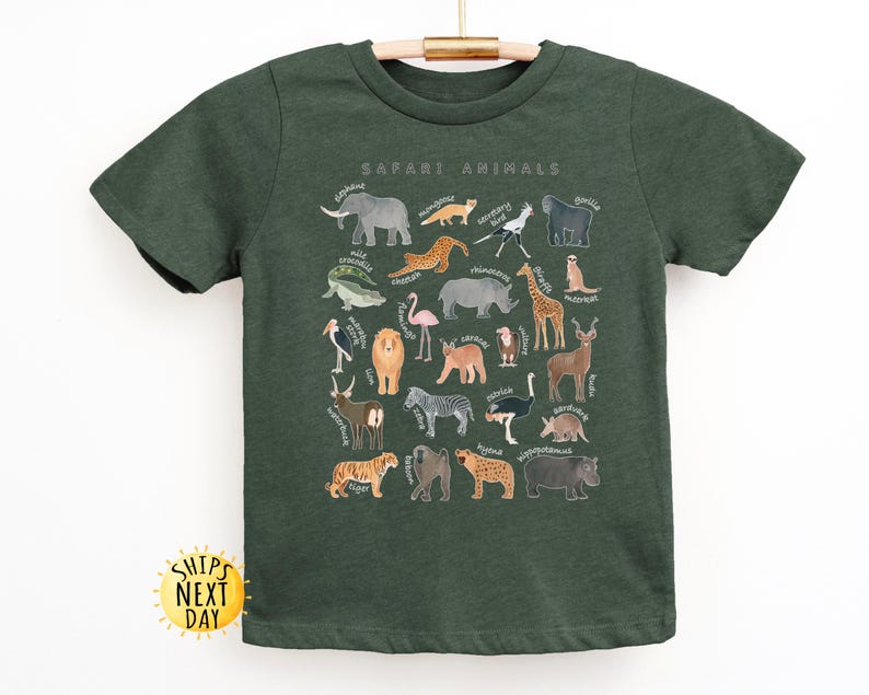May include: A dark green t-shirt with a print of safari animals. The print includes a variety of animals, including a lion, elephant, giraffe, zebra, and ostrich. The text "Safari Animals" is printed at the top of the design.