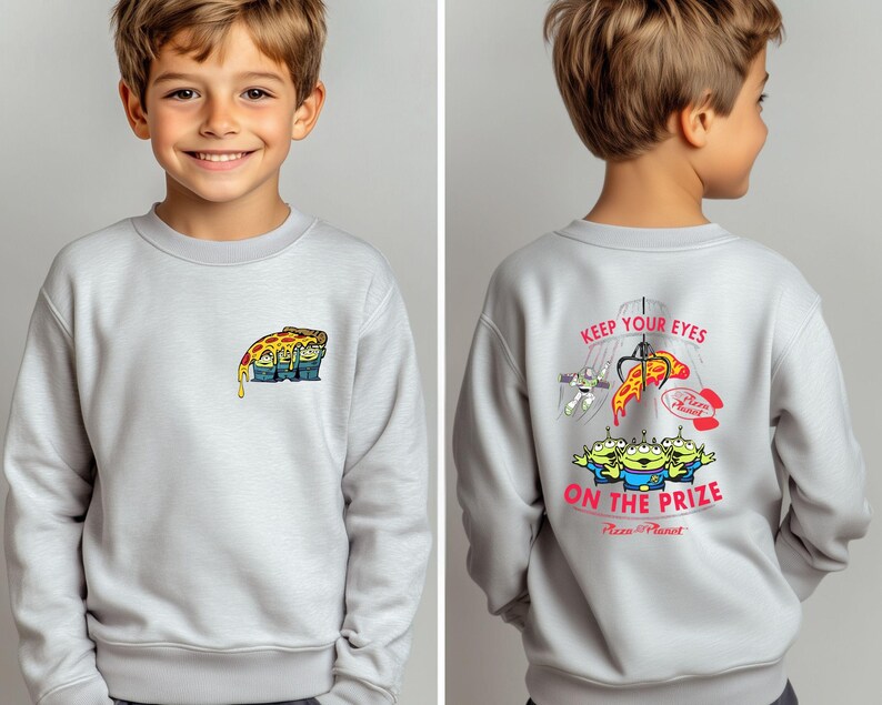 May include: Light gray sweatshirt featuring a colorful graphic of a pizza slice with three green aliens on the front. The back of the sweatshirt has the text "KEEP YOUR EYES ON THE PRIZE" with a claw machine and more aliens.