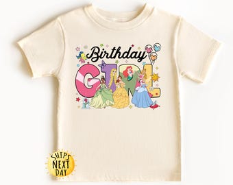 May include: A light beige t-shirt with a colorful graphic of Disney princesses and the text "Birthday Girl".