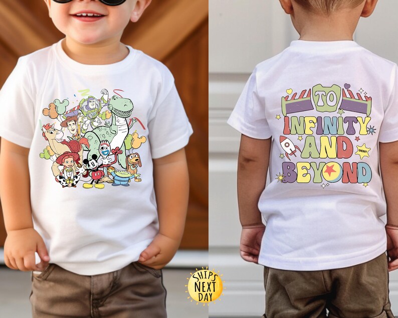 May include: White t-shirt featuring a colourful cartoon image of Toy Story characters on the front and the text "To Infinity and Beyond" on the back.