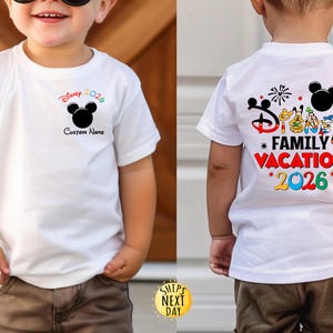 May include: White t-shirt with a colorful Disney design. The front features a Mickey Mouse head and the text "Disney 2026" and "Custom Name". The back displays "Disney Family Vacation 2026" with Mickey Mouse and friends.
