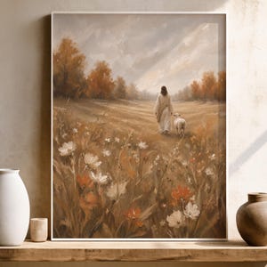 May include: A framed wall art print depicting a figure in a long white robe walking through a field of wildflowers with a small white lamb. The scene features warm autumn tones, orange trees in the distance, and a soft, cloudy sky overhead.