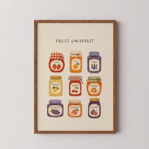 May include: A framed wall art print titled FRUIT of the SPIRIT featuring nine illustrated jars of preserves. Each jar is labelled with a virtue and decorated with corresponding fruit illustrations including strawberries, oranges, blueberries, lemons, cherries, peaches, grapes, and figs.