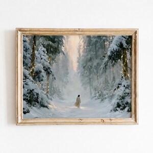 May include: A framed wall art print depicting a snowy forest path with tall, snow-covered pine trees. A solitary figure in a long, light-coloured robe stands in the centre of the path. Warm, glowing string lights are draped through the trees.