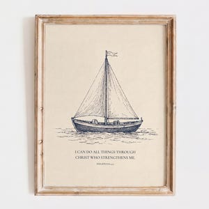 May include: A framed wall art print featuring a dark blue ink sketch of a sailboat on water against a light beige background. Below the boat, the text reads: I CAN DO ALL THINGS THROUGH CHRIST WHO STRENGTHENS ME. PHILIPPIANS 4:13. The frame is light brown wood.